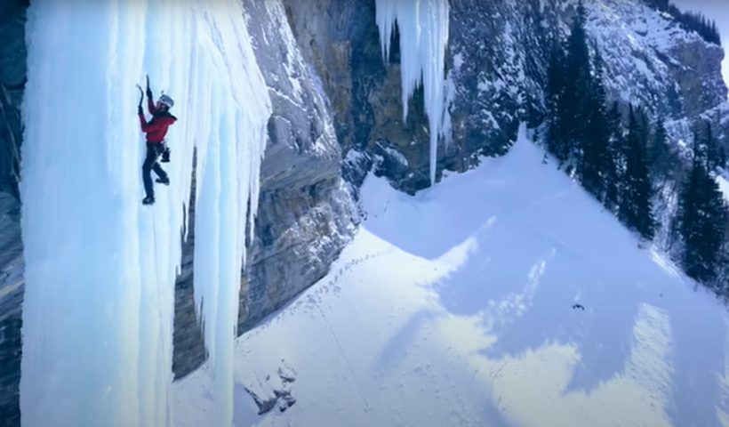 Ice climber on a thin column.